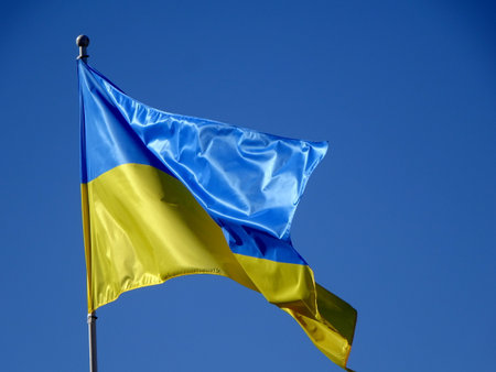 Ukrainian flags in the wind on a background of blue sky