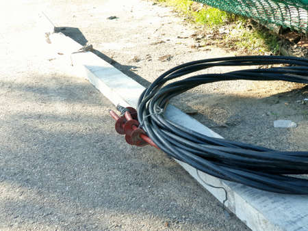 Cemented electric pipe black wire on road in jammu cityの写真素材