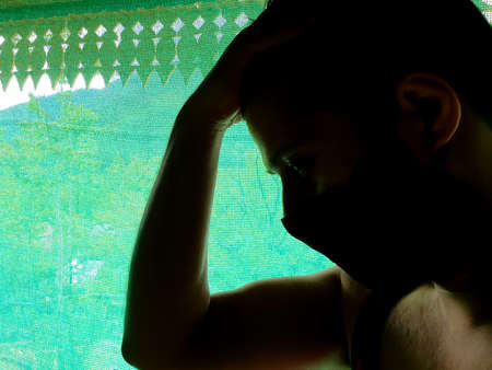 A man is sad, helpless, depressed, in tension thinks on coronavirus.Corona or cover-19 stay home...