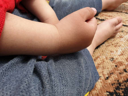 Children playing with teddy bear in a park. Body parts of Kids seems playing with toys. Children often express emotions and thoughts while playing with dolls. Kids world is beautiful greenery around.の写真素材