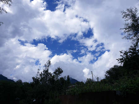 View of cloudy blue sky beautiful villages and rice fields of villagers in Indian states. Green and yellow golden colour crops in India are best destination for travellers.の写真素材