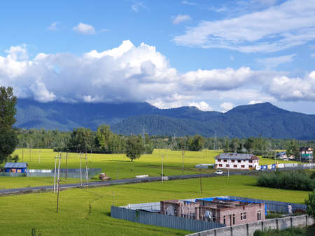 View of cloudy blue sky beautiful villages and rice fields of villagers in Indian states. Green and...