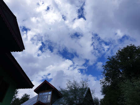 View of cloudy blue sky beautiful villages and rice fields of villagers in Indian states. Green and yellow golden colour crops in India are best destination for travellers.の写真素材