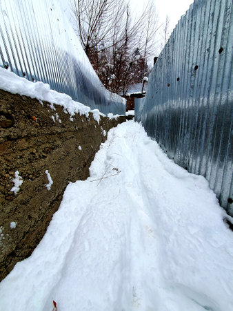 Snow White in kashmir covered hills mountains plants valley. Snow fall in Jammu and Kashmir is common from December to February, snowing attracts tourists and winter games are also played on snow.の写真素材