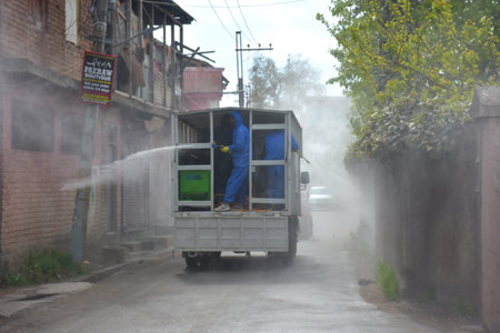 Srinagar, Jammu and kashmir India 07 August 2020. Fumigation of streets and houses by Kit wearing men warriors sanitizing and also parts of srinagar city are sanitizedのeditorial素材