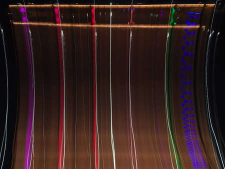Blue, red, white and purple light painting photography, long exposure, ripples and waves against a...
