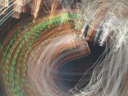 Blue, red, white and purple light painting photography, long exposure, ripples and waves against a black background. Curves and waves of neon green light against a black background.の写真素材