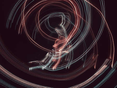 Blue, red, white and purple light painting photography, long exposure, ripples and waves against a black background. Curves and waves of neon green light against a black background.の写真素材