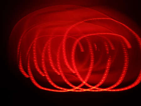Light painting long exposure photography. Year 2022 out in multicolor red numbers against...