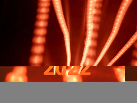Light painting long exposure photography. Year 2022 out in multicolor red numbers against...