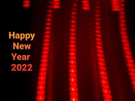 Light painting long exposure photography. Year 2022 out in multicolor red numbers against...