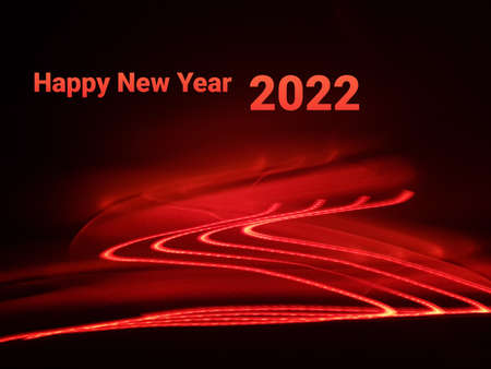 Light painting long exposure photography. Year 2022 out in multicolor red numbers against...