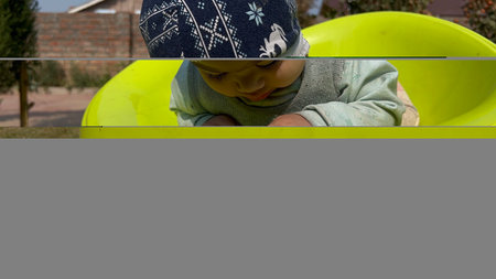 A newborn boy in an open air park smiling, looks beautiful. A healthy boy child.の写真素材