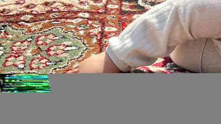 A muslim new born boy in an open air park smiling, looks beautiful an Indian organ face. A healthy boy child.の写真素材
