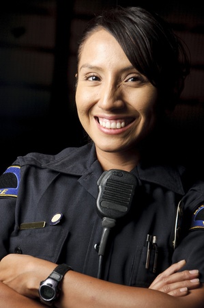 a female police officer smiling at night and posing for her portrait. の写真素材