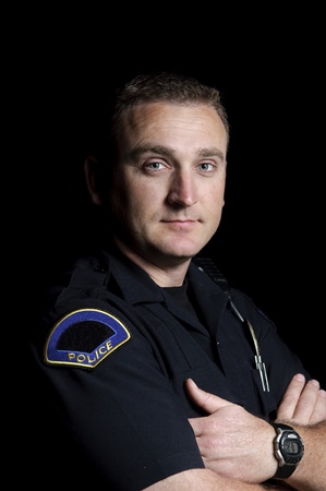 a police officer standing in the night during a patrol shift. 