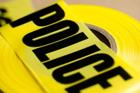A close up of yellow crime scene tape.  The depth of field was shallow on purpose for effect. の写真素材