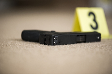 a close up of a gun at a crime scene
