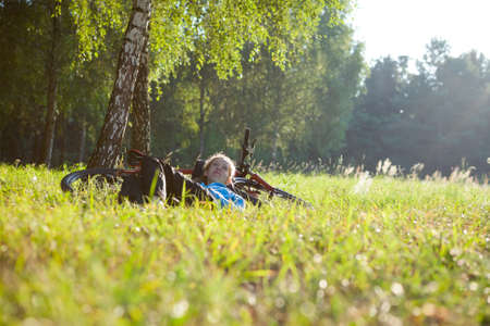 Young girl cyclist enjoying relaxation in spring parkの写真素材