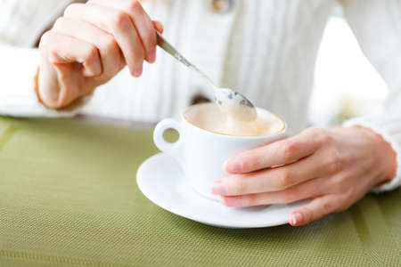 Closeup of cup coffee and woman hands  Cup of hot beverage  Girl on a coffee-breakの写真素材