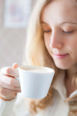 Coffee  Beautiful young woman holding in hand a cup of coffee  Coffee-time