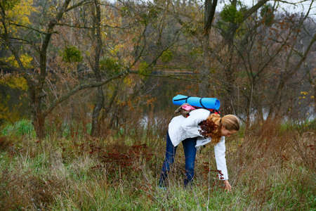 Woman hiker resting on the autumn nature. Active Lifestyle