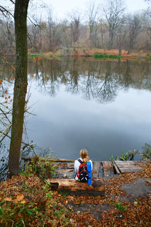 Woman hiker relax on the riverbank. Active Lifestyleの写真素材