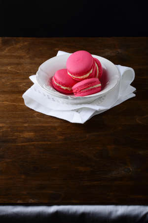 Strawberry Macaroon in a plate on wooden boards. Sweet Dessertの写真素材