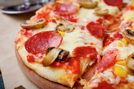 Italian traditional Pizza with sausage and mushrooms closeupの写真素材