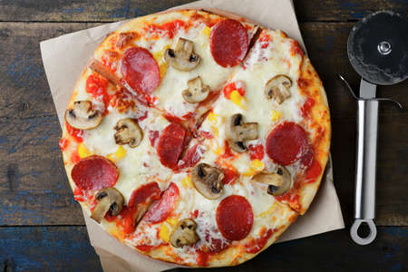 Sliced Pepperoni Pizza with mushrooms. Traditional italian foodの写真素材