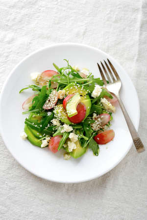 Light Avocado Salad with grape and arugula. Top viewの写真素材