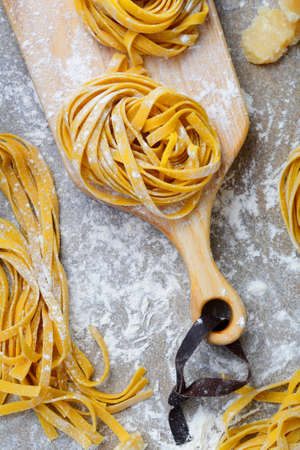 Fettuccine pasta and cutting board closeup. Top viewの写真素材