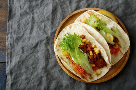 Plate with two Mexican Taco and ground beef, vegetables. Top viewの写真素材