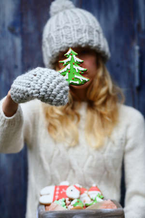 Green christmas tree cookies in hand, holiday backgroundの写真素材