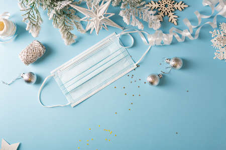 Christmas gift in hands on white surface, flat lay