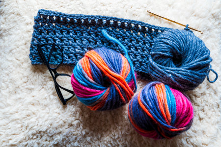 Close-up of multicolored and blue natural wool yarn balls. home hobby.の写真素材
