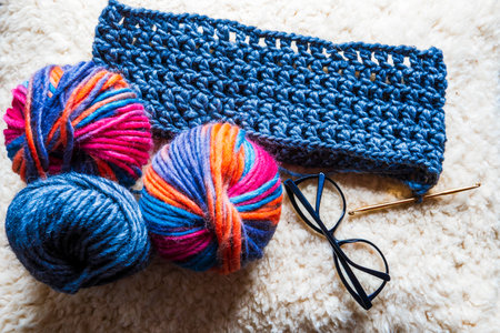 Close-up of multicolored and blue natural wool yarn balls. home hobby.