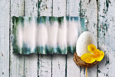 easter eggs on wooden table with board の写真素材