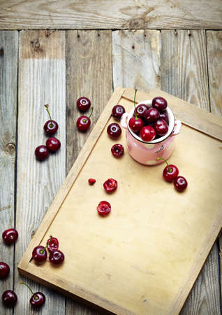 sweet cherry in a bowl on wooden tableの写真素材