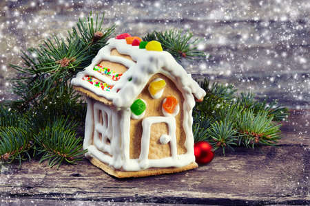 Christmas background.Gingerbread house on wooden background