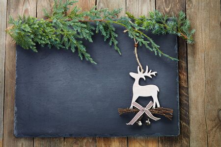 Christmas decoration  on slate and wood background.の写真素材