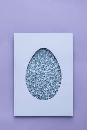Easter paper egg of lilac color polystyrene foam on lilac background.の写真素材
