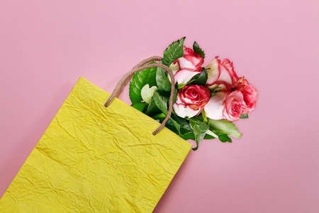 Mock-up of Recycled blank kraft paper shopping yellow bag for lunch, food,purchases on pink paper...