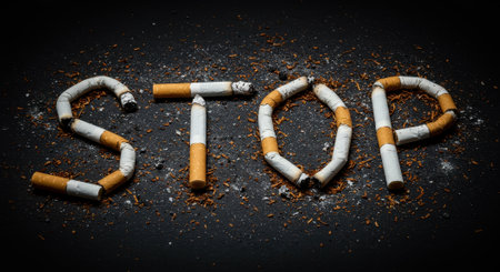 Cigarettes arranged to spell STOP on a dark background, symbolizing anti smoking campaign and the dangers of tobacco use, with tobacco shavings scattered around.の素材