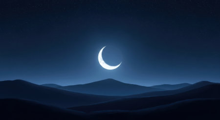 A bright crescent moon illuminates a serene night sky above dark, rolling hills, with subtle stars visible. This tranquil landscape evokes peace and mystery.の素材