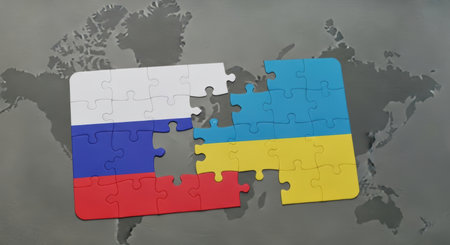 Two jigsaw puzzles representing russia and ukraine flags, with a missing piece, lie on a world map. This symbolizes the complex relationship and ongoing conflict between the two nations.の素材