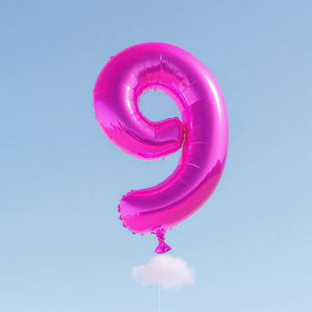 Vibrant fuchsia number 9 balloon floating gracefully in a clear light blue sky, with a small fluffy white cloud attached, symbolizing celebration, anniversary, or special events.の素材