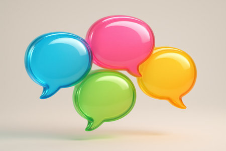 Four vibrant, glossy 3D speech bubbles in blue, pink, green, and yellow, representing communication, discussion, and online interaction.の素材
