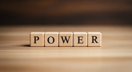 Wooden blocks arranged to spell the word POWER, representing concepts of strength, influence, energy, and leadership. ideal for business, motivation, and abstract themes.の素材