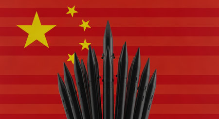 Multiple black ballistic missiles stand prominently against the vibrant red and yellow flag of china, symbolizing military strength and geopolitical power.の素材